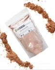 Package of slowcocoa cacao powder with cacao powder around its perimeter