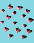 Red heart-shaped slowcocoa chocolate bunnies and Easter eggs on a light blue background