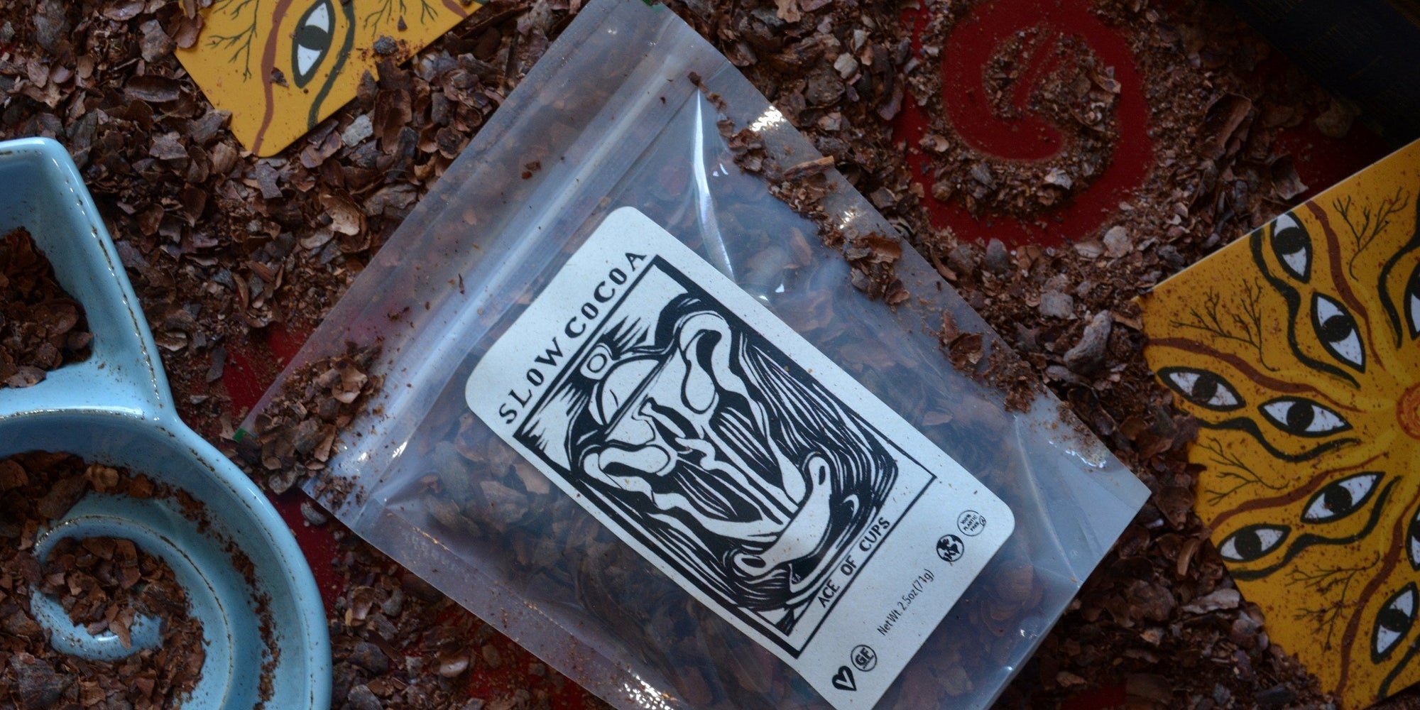 slowcocoa Cacao Tea: the Ace of Cups pouch of roasted cacao husks on a bed of loose husks
