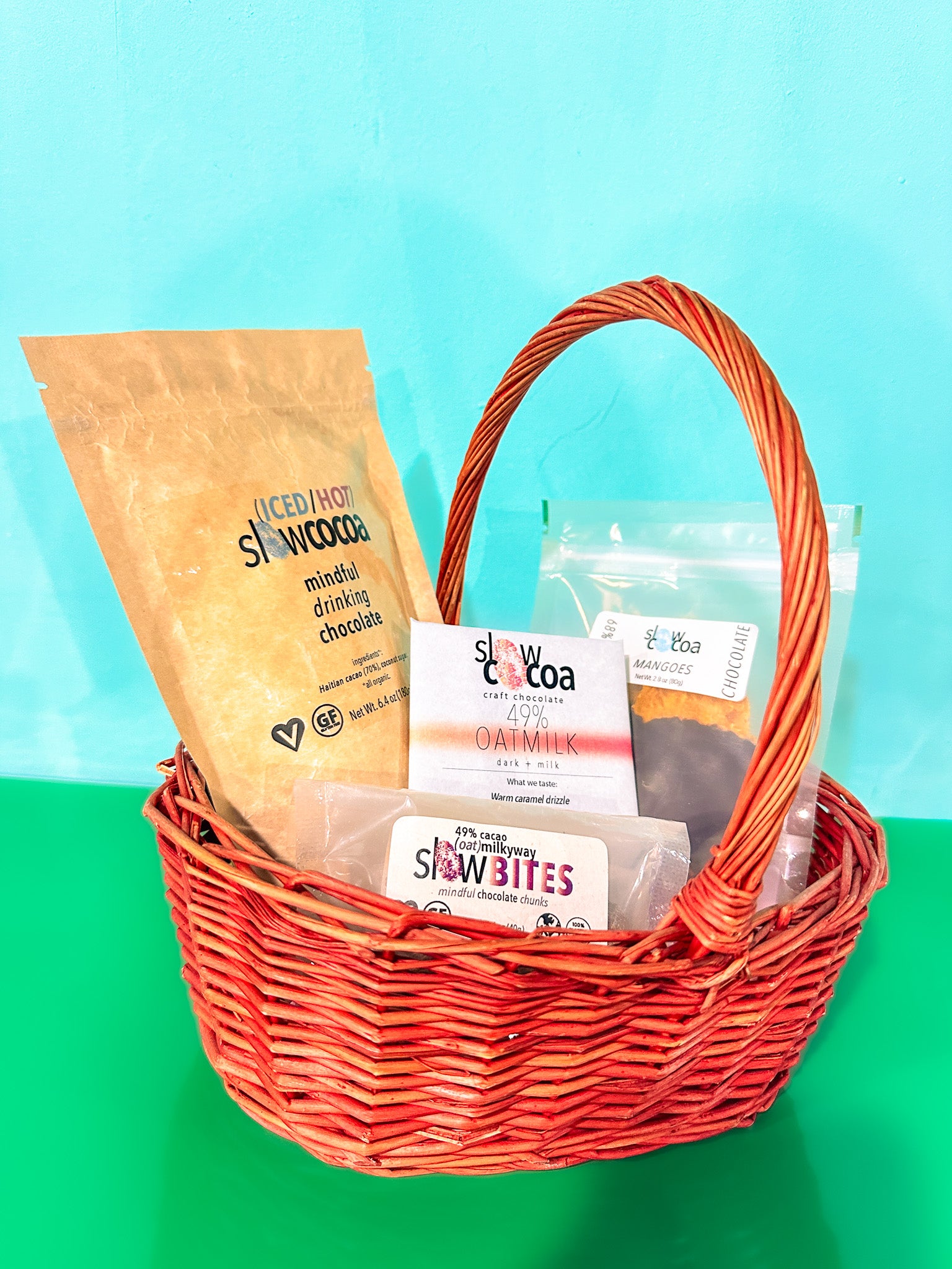 Basket with slowcocoa products on a green and blue background