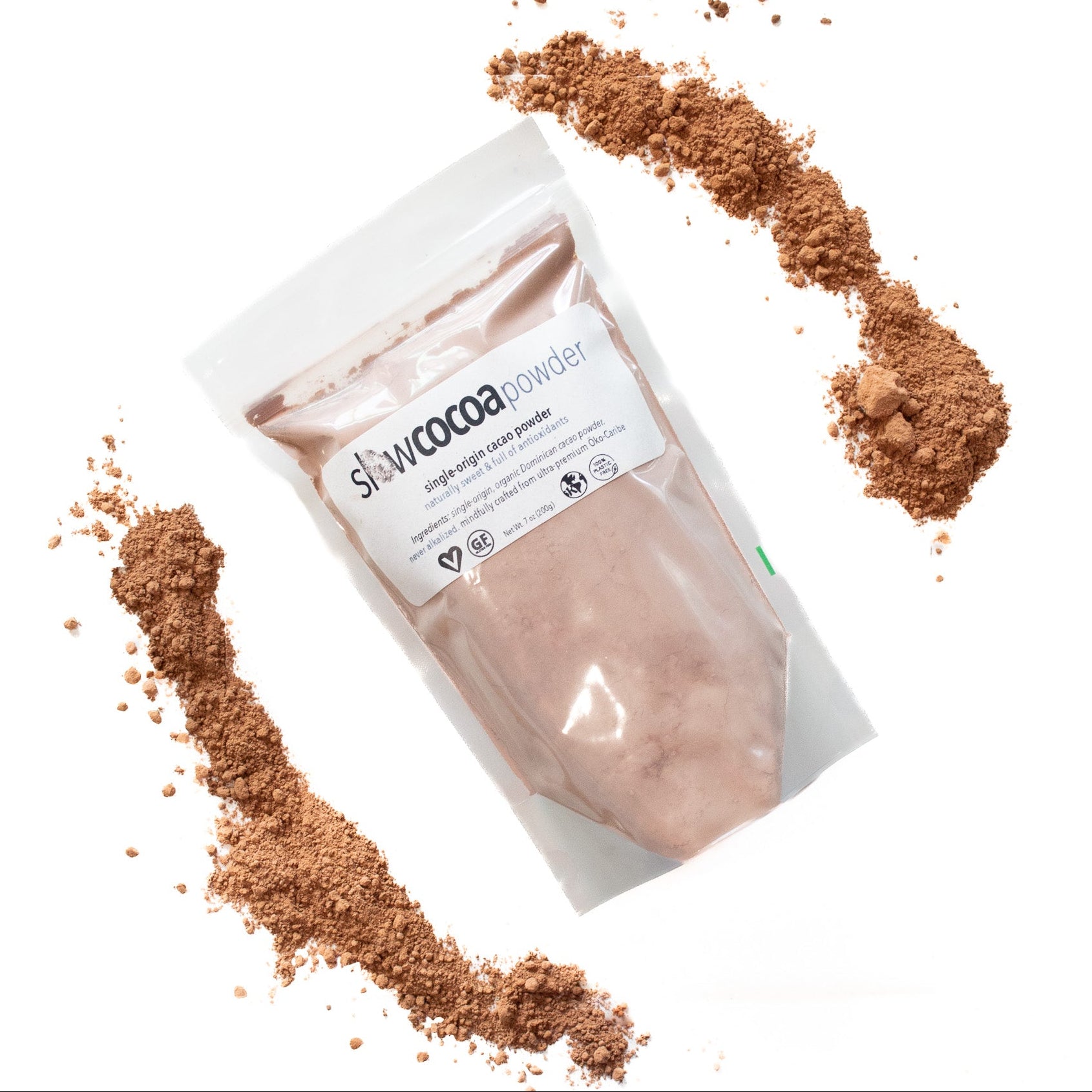 Package of slowcocoa cacao powder with cacao powder around its perimeter