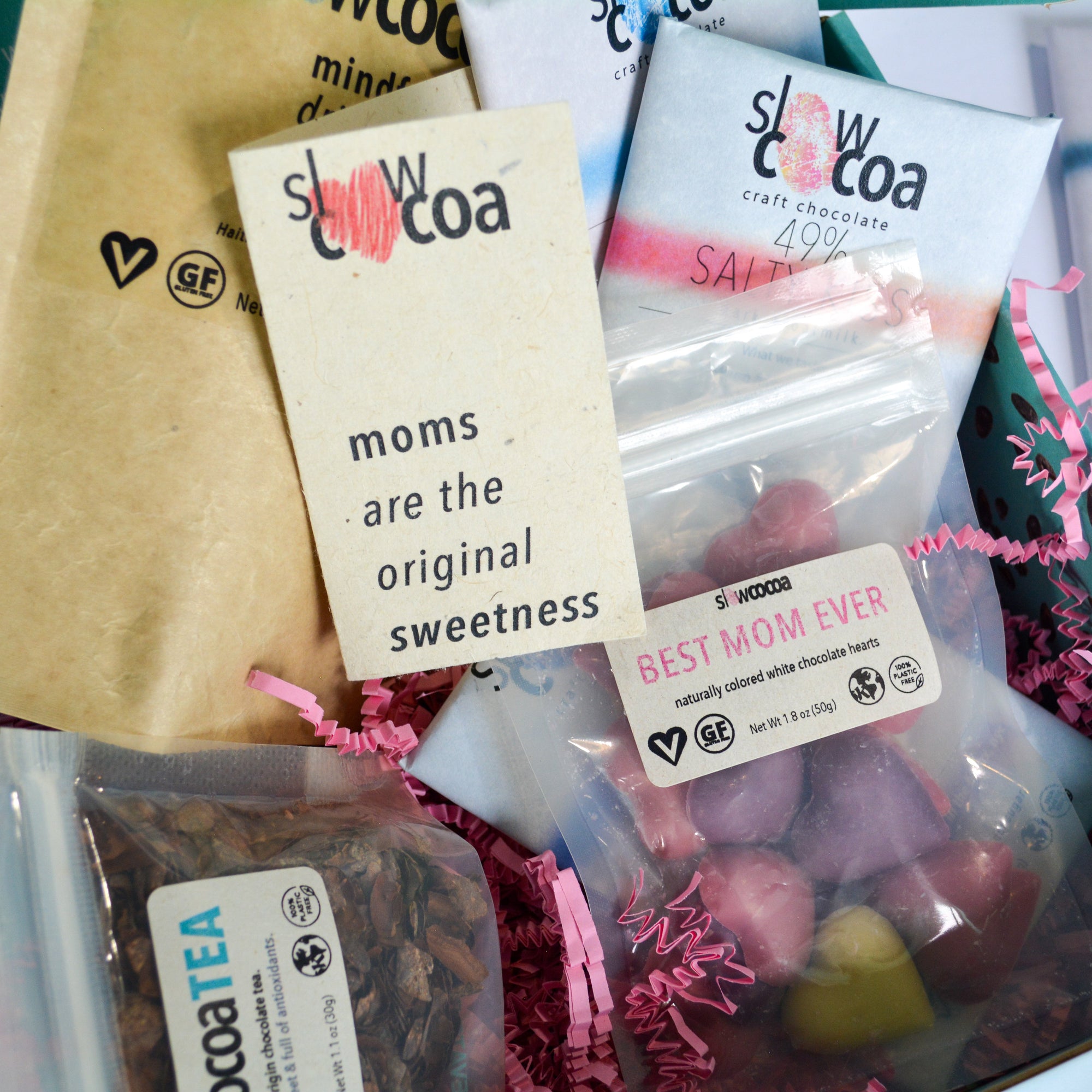 Assorted slowcocoa products including chocolate bars and tea with promotional text.