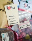 Assorted slowcocoa products including chocolate bars and tea with promotional text.